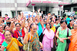 Activists of the Uttarakhand Rajya Nirman Senani Manch hold a protest at the District Industries Centre in Dehradun on Tuesday