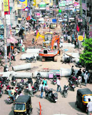 An earth mover at work in the Jewel Chowk area blocking the ever-busy road in Jammu on Tuesday.