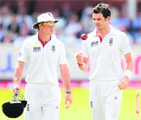 England captain Andrew Strauss (L) speaks to James Anderson on the fifth day of the Lords Test.