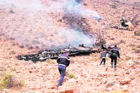 Rescuers arrive at the site where a military transport plane crashed in southern Morocco on Tuesday