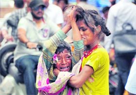 Fighting tooth and nail: Two children fight over alms at a busy crossing in Dehradun on Wednesday