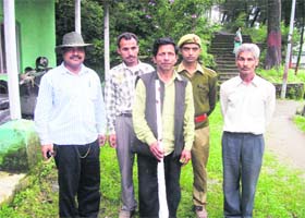 A suspected poacher with a gun who was arrested by forest officials in Mussoorie