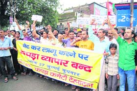 Cloth merchants hold a demonstration against the imposition of VAT on cloth by the state government, in Dehradun on Wednesday