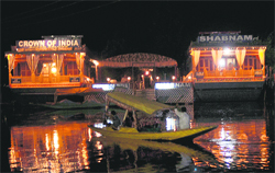 Tourists enjoy a shikara ride on the Dal Lake in Srinagar on Tuesday