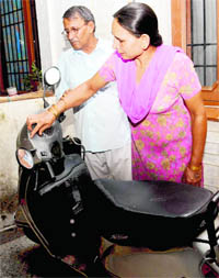 Nehas father Rajvir Singh Ahlawat and mother Kamlesh point towards her scooter bearing scratches caused by stones after she was killed.