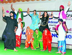 Students participate in a cultural programme by NCC cadets at Graphic Era University in Dehradun on Thursday