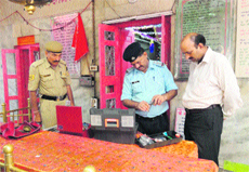 A police team inspects the Hateshwari temple after the theft near Sundernagar on Thursday. 