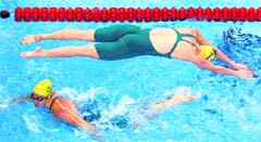 Australias Bronte Barratt (top) jumps into the pool past her team mate Jade Neilsen in the women's 4x200m freestyle heats at the 14th FINA World Championships in Shanghai