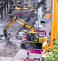 Bulldozers clear the debris near the government headquarters in Oslo on Thursday following last weeks bomb attack. The Norwegian police said they have ended a six-day search for those missing in Utoeya island attack