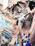 Rescue workers try to retrieve the body of a girl from a collapsed building in Amritsar