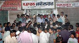 People crowd the jewellery shop where the firing incident took place in Bathinda on Friday.