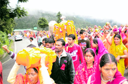 Devotees accompany the doli of Nag Devta near Mussoorie on Friday