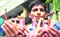 Members of the National Panthers Students Union hold a candlelight protest on Friday against the delay in making the Central University of Jammu functional