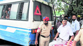 District Bar Association Ashok Mittal blocks the way of a police vehicle at the District Courts Complex in Ludhiana on Friday.