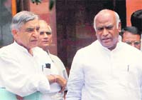 Union Labour Minister Mallikarjun Kharge (R) and Parliamentary Affairs Minister Pawan Bansal leave after a Cabinet meeting on the Lokpal Bill in New Delhi