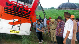 Local residents and cops taking out an injured from the bus that overturned on the Moga-Kotkapura road on Friday.