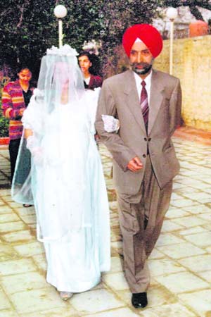 Navreet, a Sikh from Kashmir, who got married to Milton, a Protestant, walks down the aisle with her father