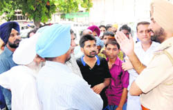 A cop pacifies agitated relatives of the murdered Harnek Singh at the GMSH, Sector 16, Chandigarh