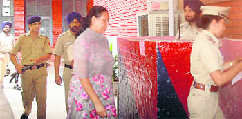 DSP Raka Ghirra, facing charges of bribery, illegal possession of arms and liquor, being led into the Sector-11 police station for questioning in Chandigarh 