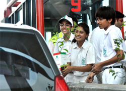Schoolchildren gift a sapling to a passer-by at Delhi-Gurgaon toll plaza in Gurgaon on Saturday