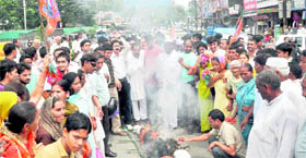 Workers of the BJP burn an effigy of the Congress in Dehradun on Saturday.