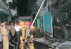 Fire Brigade personnel try to extinguish fire in a shop at Hamirpur 