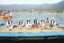 Folk singers perform during the inaugural function of Jeshn-e-Dal organised by the state police at the Dal Lake in Srinagar on Friday. 