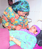 A woman consoles her injured relative at a hospital in Anantnag on Saturday. 