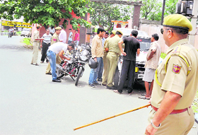 Policemen check documents of vehicles ahead of Independence Day in Jammu on Saturday.