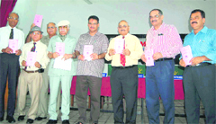 Members of the Dehradun Ex-servicemen League release a magazine at a function in Dehradun on Sunday. 