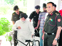Brig M Ganguly, Commandant, Military Hospital, Roorkee, gives a wheelchair to a veteran soldier at a health camp in Dehradun on Sunday. 