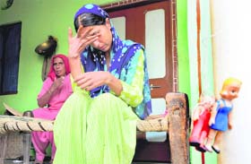 Chandrapati and her daughter, Seema (right), sister of Manoj (an honour killing victim), burst into tears talking to The Tribune about the opposition to the screening of Khap film at Karora village of Kaithal district on Sunday