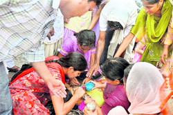 An activist of the EGS Teachers Union being revived after she collapsed due to hot and humid weather while protesting in Ludhiana on Sunday