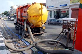 A jet suction machine clearing a choked sewer line in Bathinda on Monday