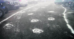 Limestone powder sprinkled over potholes on a road in Mussoorie.