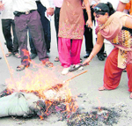 UKD (Panwar) workers burn an effigy of the state government in Dehradun on Monday.