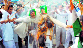 Congress leaders burn effigies of INLD supremo Om Prakash Chautala and his son, Ajay Chautala, in Faridabad on Monday.
