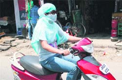 A girl rides a scooter in Jammu