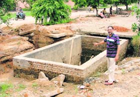 Conservation: A resident of HIG flats in Rajguru Nagar points towards a rainwater-harvesting well in Ludhiana