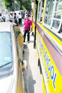 A damaged car after it was hit by a school bus at BRS Nagar in Ludhiana on Monday