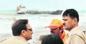 Policemen near MT Pavit on Mumbai's Juhu Chowpatty beach 