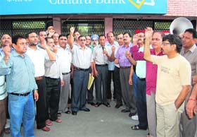 Bank employees hold a demonstration in support of their demands in Dehradun on Tuesday
