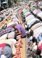 Devotees offer prayers at Budshah Chowk in Srinagar on Tuesday. 
