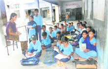 Students are forced to sit in a verandah of Government Primary School, Reru, which also houses an ayurvedic dispensary and a sub-post office.
