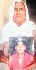 Grandmother of Sukhjyot Singh with his picture. 