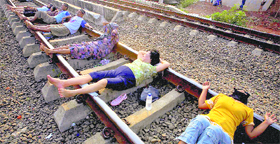 Villagers lie on a railway track and wait for a train to rattle by for electricity therapy in Rawa Buaya, Jakarta, Indonesia. People on the outskirts of the capital have been participating in the treatment believing that the electricity from the track could cure various diseases.