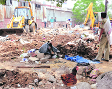 The enforcement staff of the municipal corporation removes encroachments at Colony Number 4 in Chandigarh on Wednesday