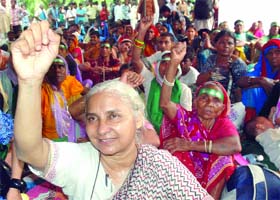 Social activist Medha Patkar with members of the National Forum of Forest demonstrates near Parliament in New Delhi on Wednesday