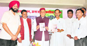 Chief Minister Prem Kumar Dhumal releases a book titled Khabardar Jo Vyangya Likha, authored by Gurmit Bedi, DPRO, Una, in Dharamsala