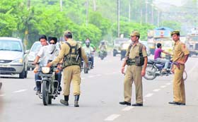 Security personnel check vehicles on the Banihal Cart road in Jammu on Wednesday